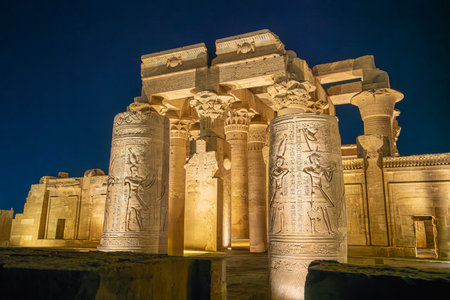 Majestic columns with carvings at Temple of Kom Ombo Egypt glow under night lights during a spring evening visit, highlighting ancient architecture.の写真素材