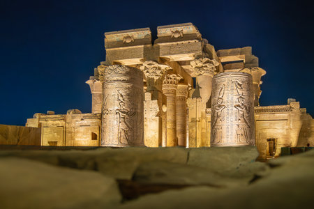 Majestic columns with carvings at Temple of Kom Ombo Egypt glow under night lights during a spring evening visit, highlighting ancient architecture.の写真素材