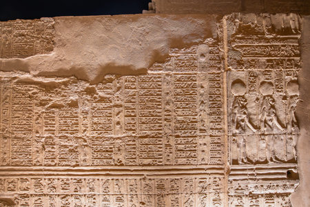 A detailed look at the ancient hieroglyphic carvings and text on the walls of the Temple of Kom Ombo...
