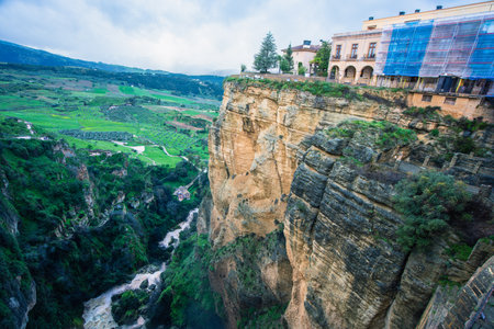 Dramatic view of Ronda Spain with cliffside buildings and deep gorge carved by Rio Guadalevinの写真素材