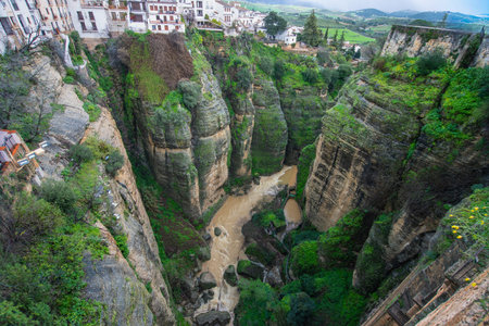 Dramatic view of Ronda a picturesque town in Andalusia Spain perched on cliffs overlooking the deep El Tajo gorge and the winding Guadalevin Riverの写真素材