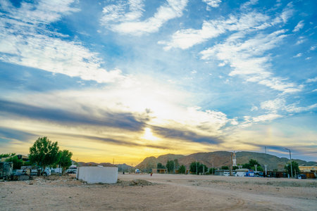 Sunset view at a rest stop near Hurghada Red Sea Resort, Egypt, with buses, mountains, and dramatic clouds, captured in spring 2025 during a bus journey.の写真素材