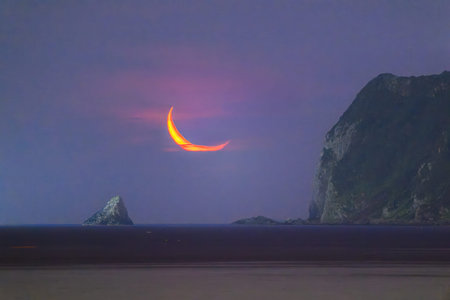 Stunning nightscape time lapse of a bright orange crescent moon over Keelung Island Taiwan Steep...