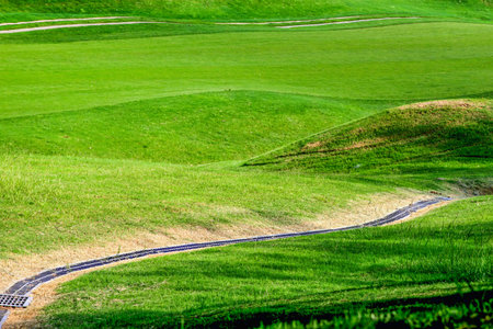 Panoramic view of the lush green fairways at Golf Course in Lukou, Taoyuan City, surrounded by rolling hills and dense forest, ideal for outdoor leisure.の写真素材