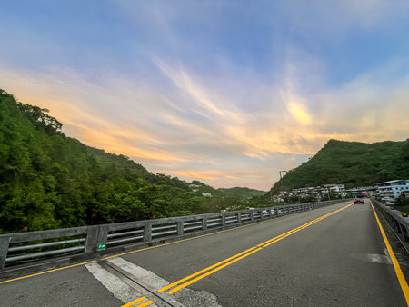 Stunning dawn sky above silhouetted mountain ranges and forest.の写真素材