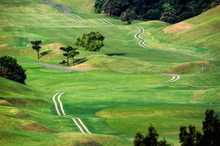 Panoramic view of the lush green fairways at Golf Course in Lukou, Taoyuan City, surrounded by rolling hills and dense forest, ideal for outdoor leisure.の写真素材