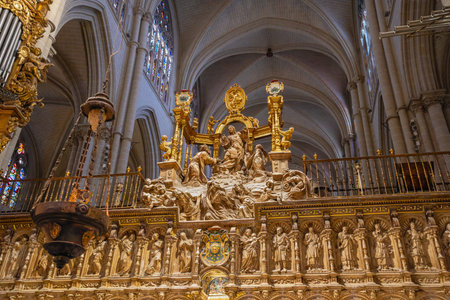 Toledo, Spain - March 14, 2025: Intricate golden sculptures and gothic arches inside the Toledo Cathedral, a major historic religious landmark.のeditorial素材
