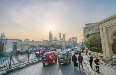 Cairo, Egypt - January 20, 2025: A view of the historic Al-Azhar Mosque and busy street traffic seen from a tourist bus on the way to Khan el-Khalili market.