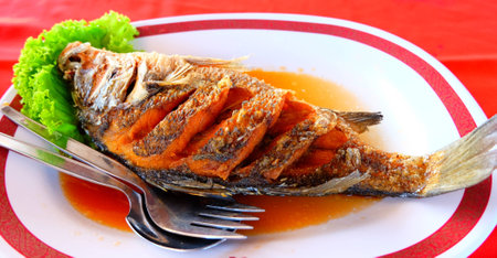Fried snapper with fish sauceの写真素材