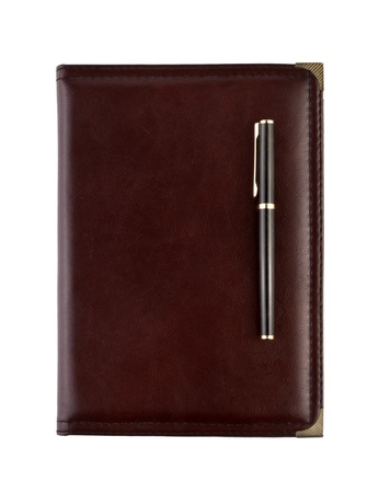 Brown leather notebook and pen isolated on whiteの写真素材