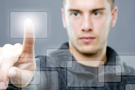 Young man pressing a modern touch button on virtual display