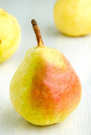 Fresh pears on white kitchen table - selective focusの写真素材