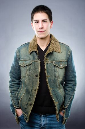 Studio shot of handsome young man on gray backgroundの写真素材