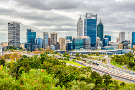 Perth city with modern glass buildings towering above the freeway below.のeditorial素材