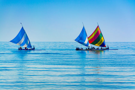 A traditional indonesia outrigger canoe converted into a sailing boat for tourists.のeditorial素材