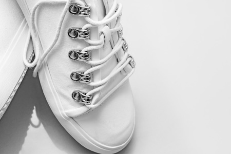 Women's white studded stylish shoes with a white background.の写真素材