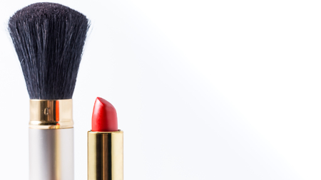 Make up brush with red lipstick on white background with copyspace.の写真素材