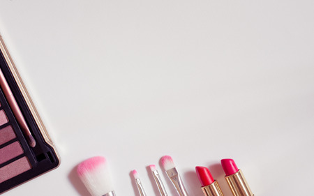 Make up brushes /lipstick layflat image with white copyspaceの写真素材