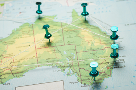 Map of Australia with pins connected by string, concept image depicting travel route.の写真素材