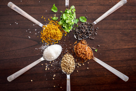 herbs and spices on wooden table top  -shot from above