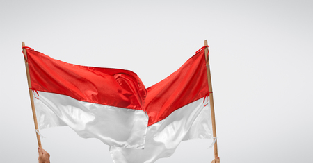 Indonesian independance day  with two flags waving over background.の写真素材