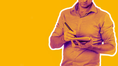 Unknown man wearing casual  collared shirt using tablet with a pen - technology concept with bright...