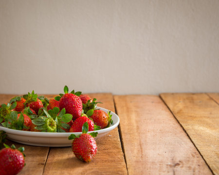 Ripe red strawberries on wooden table with copy space for text. Simple healthy food concept.の写真素材