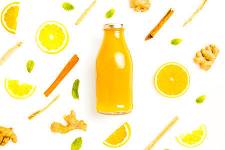 ginger and citrus healthy drink in glass bottle with other ingredients - lay flat healthy lifestyle...