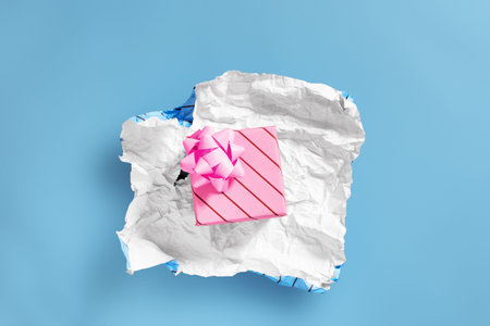 unwrapping present to find another layer of wrapping - Celebrations and events concept image with...