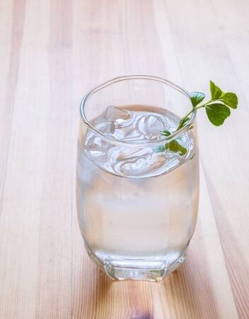glass of cold water on wooden tableの写真素材