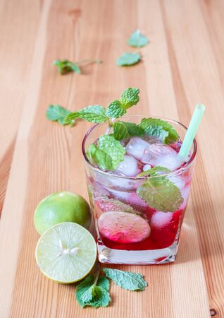 red lemonade with mint and lime on wooden table, Summer drinks with iceの写真素材