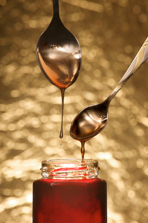 Red jam on golden backgroundの写真素材