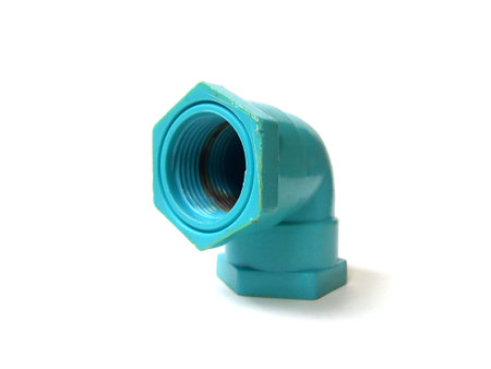 Close up of PVC water pipe fitting isolated on white background.