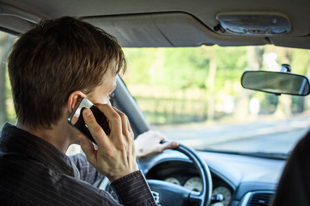 Calling on mobile while driving a carの写真素材