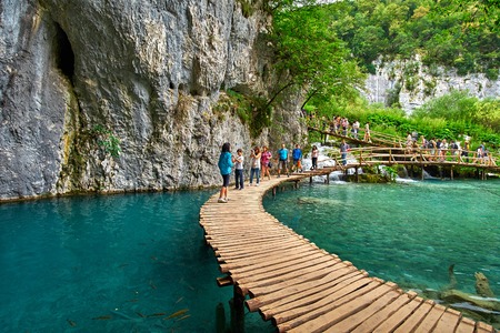 PLITVICE, CROATIA - JULY 29: Tourist enjoy sightseeing the lakes and wonderful landscapes at the Plitvice natural Park in Croatia during the summer holidays, on July 29th, 2016 in Plitvice, Croatiaのeditorial素材