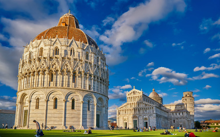 ITALY, PISA, PIAZZA DEI MIRACOLI - 02 MAY 2017. Tourists relaxing on the Grass next to the Leaning Tower of Pissa.のeditorial素材