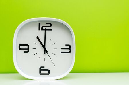 White clock on green backgroundの写真素材