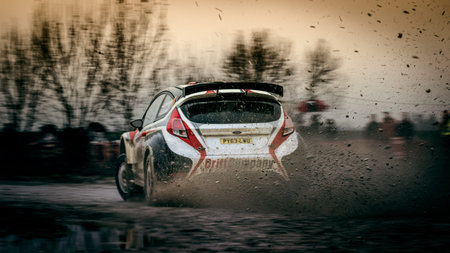 Ford fiesta rally car drift  on the gravel, muddy surface