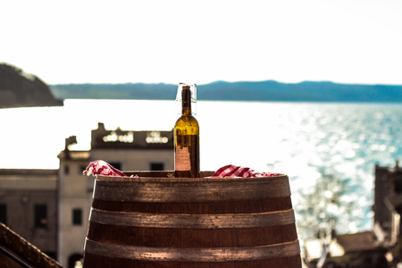 Bottle of wine over a barrelの写真素材