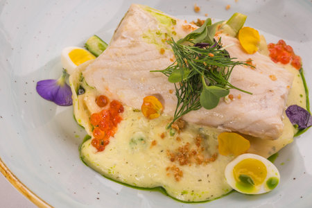 A sturgeon with fennel and to young people katrofely with pelmeni from a smoked sterdyala on a plateの写真素材