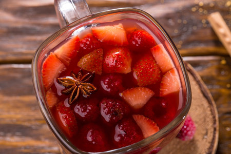 A grog with dark rum, with berries and spices in a glass cupの写真素材