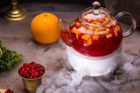 Tea with berries of a cranberry, strawberry, orange and mint, with addition of sugar syrup