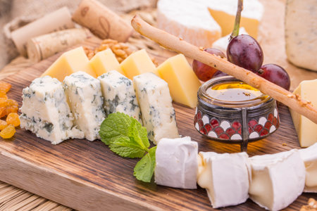 Cheese, is served with honey and walnut on a wooden board