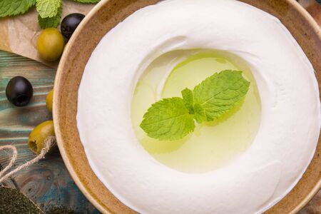 House cottage cheese with addition of olive oil with garlic and mintの写真素材