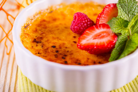 Caramel cream with raspberry and strawberry on the basis of cream, with a crispの写真素材