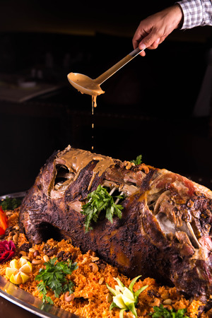 The ram, is served on a dish with rice, vegetables and spices. Is served with sauceの写真素材