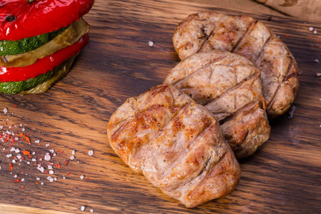 The pork made on a grill with paprika, a vegetable marrow and an eggplant