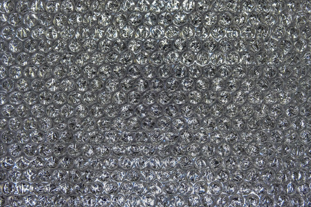 Bubble wrap texture on a black backgroundの写真素材