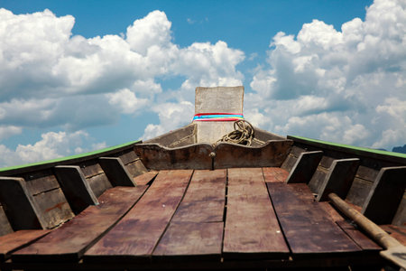 Commuting on the boat with clear blue sky and white cloudsの写真素材