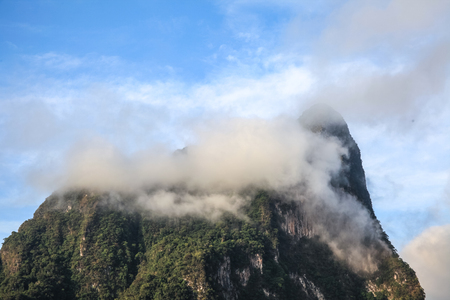 Top of mountains covered by clouds and fog in the morning of the sunny day.の写真素材